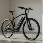 Electric bike with removable battery pack plugged into a wall charger in a bright garage