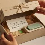 Beautifully packaged Chargie product box being opened with eco-friendly packaging and glowing USB device, unboxing experience photography